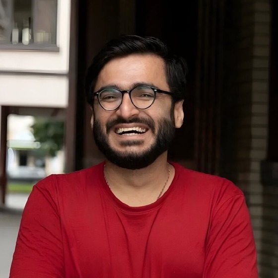 Vineet laughing in a red t-shirt